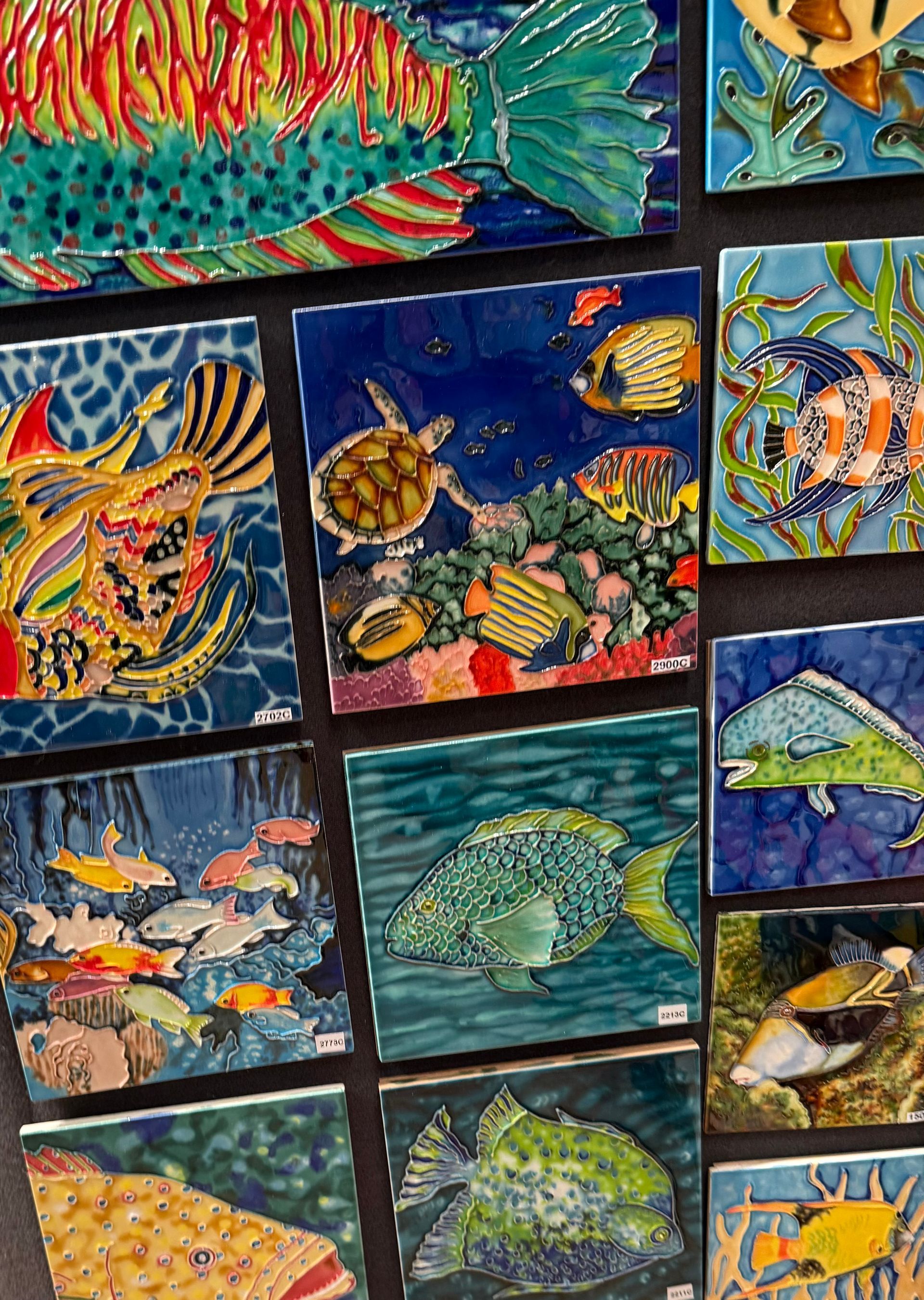 Colorful mosaic-style paintings of fish and underwater sea life in bright blues, yellows, and greens