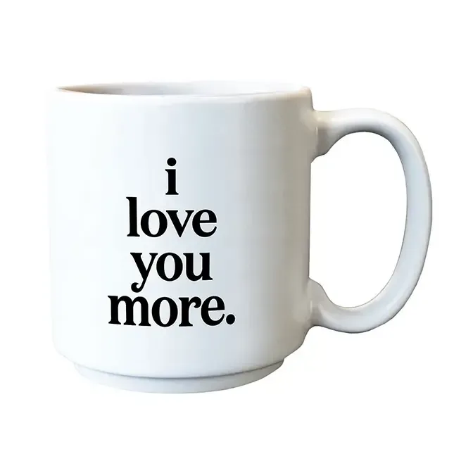 White mug with the words “i love you more.” printed in black text.