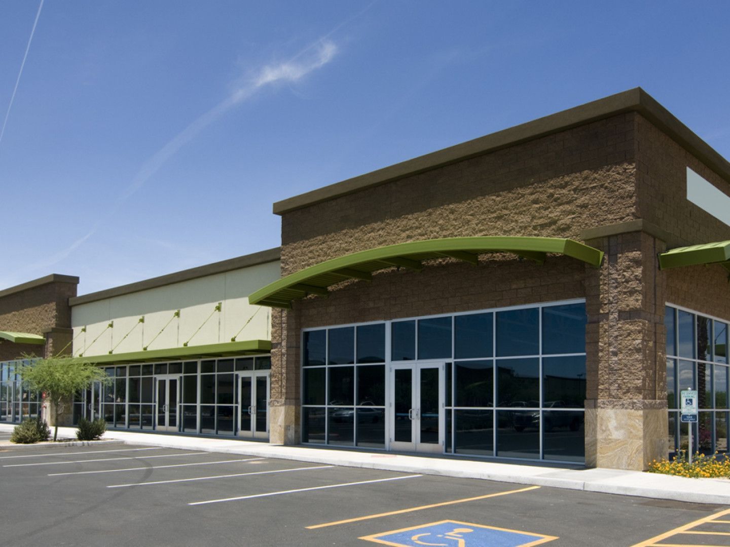 A building with a handicapped parking spot in front of it