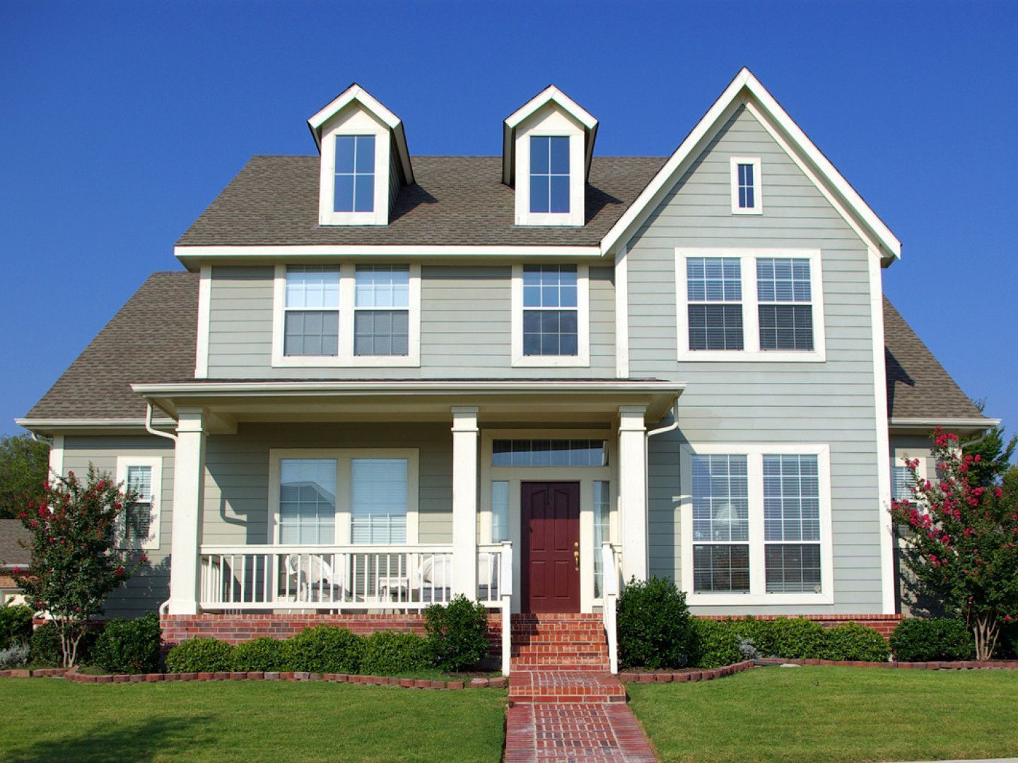 A large house with many windows and a red door