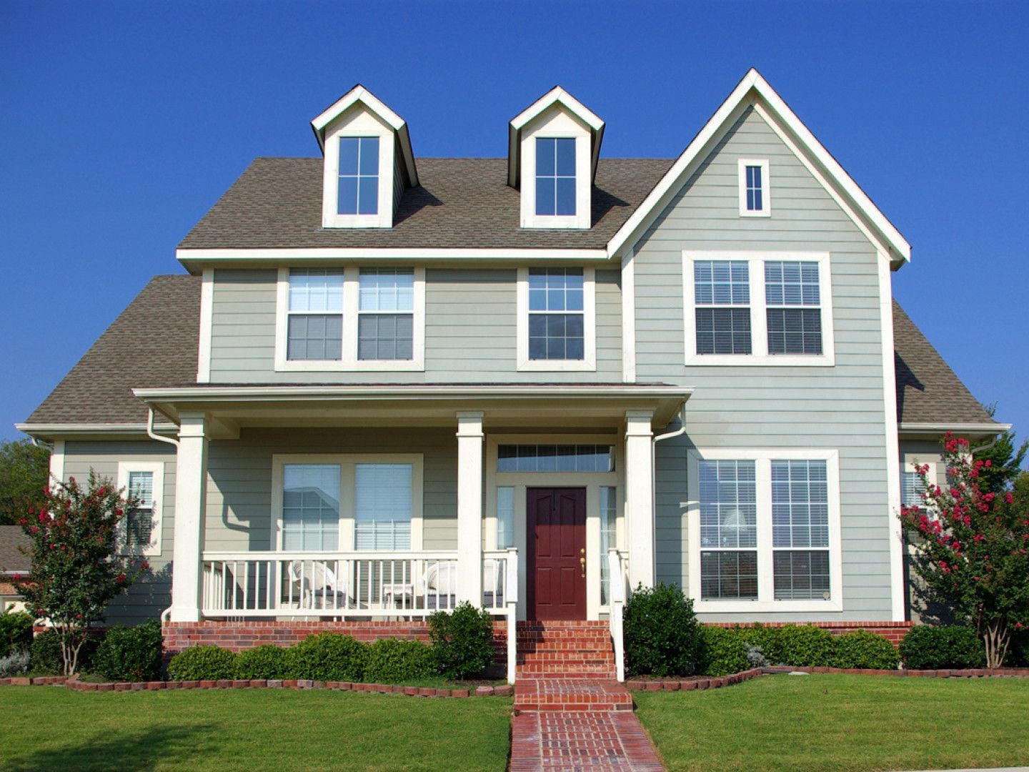 A large house with many windows and a red door