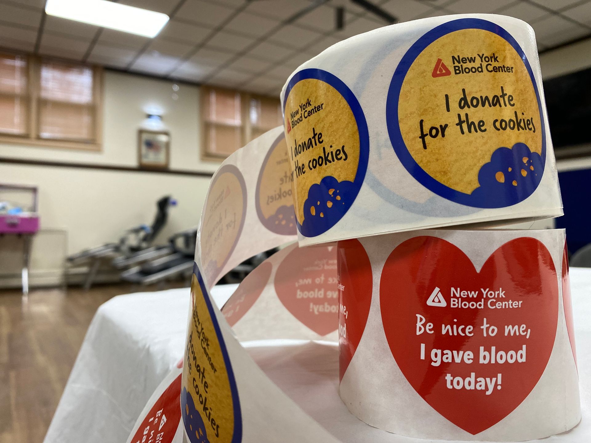 Rolls of stickers for the New York Blood Center, with text such as 