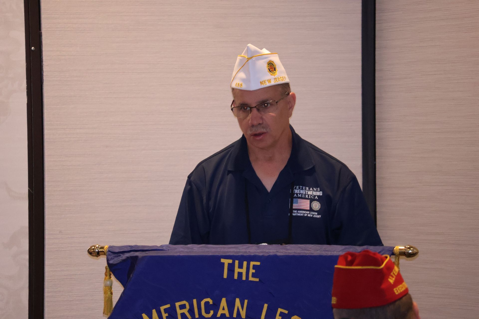 Man speaking at a podium with 
