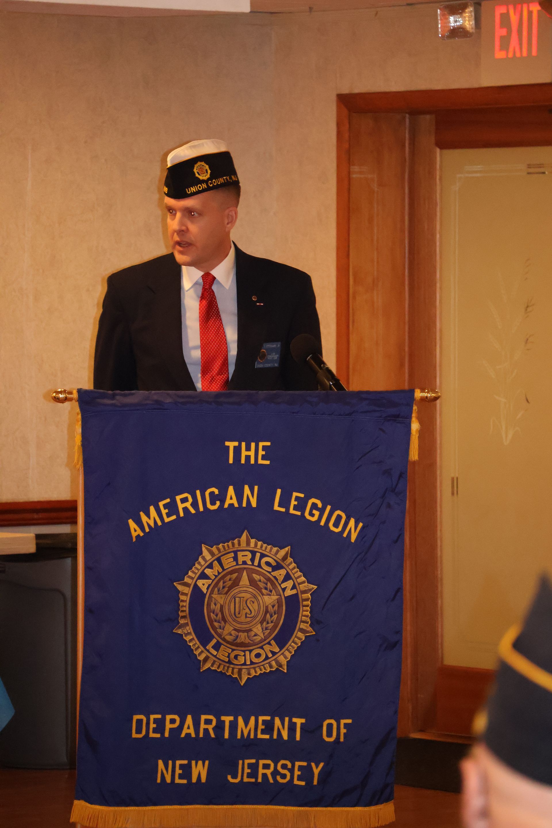 Man speaking at a podium with 