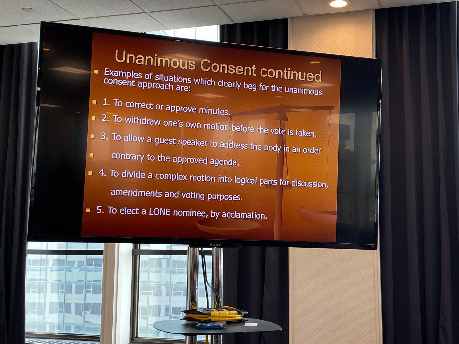 A presentation screen displays 
