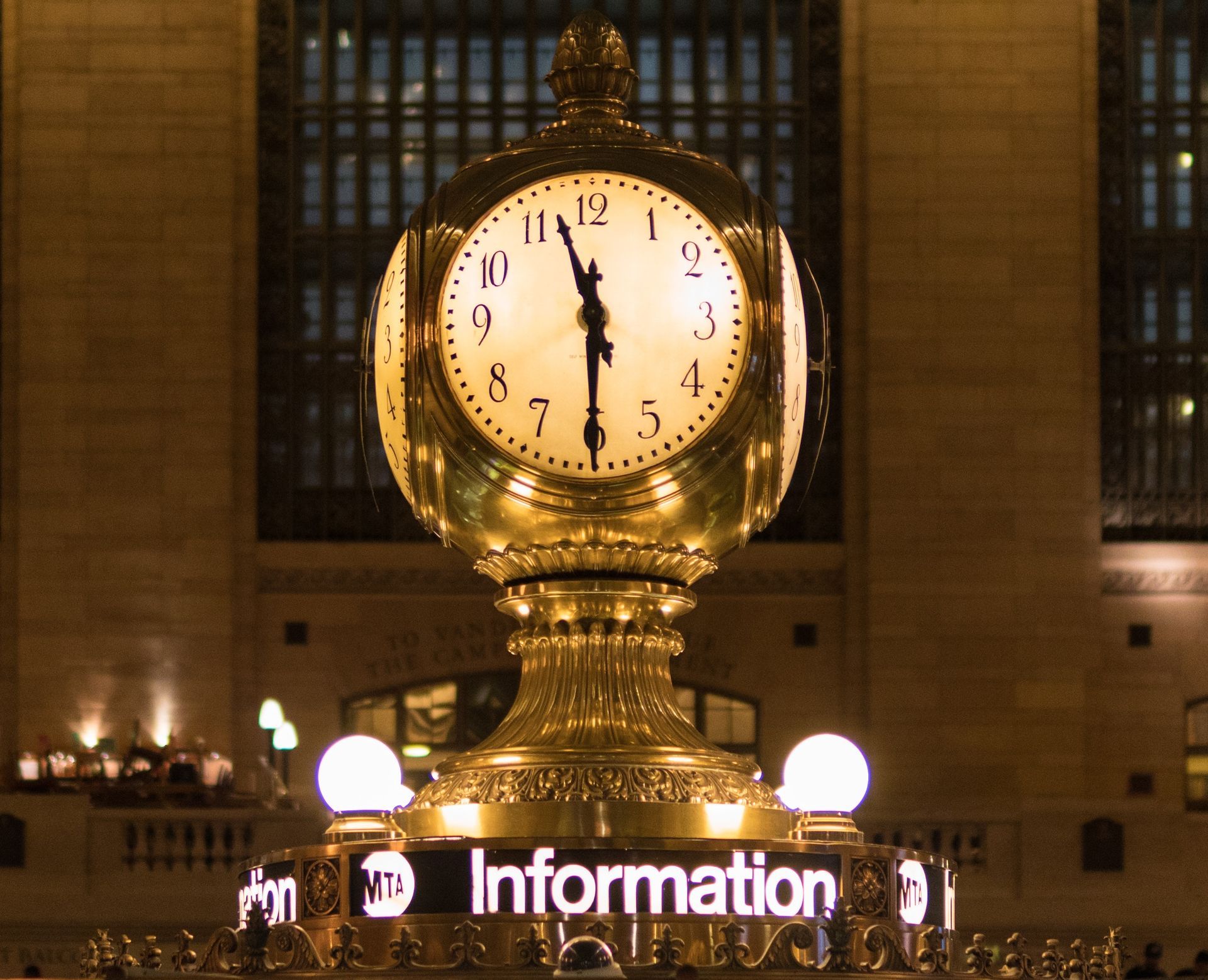 Grand Central Terminal clock, gold, face lit, reads nearly 11 o'clock, 