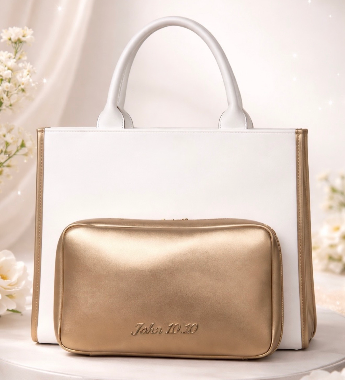 White tote bag with a gold zip pouch against a soft floral background
