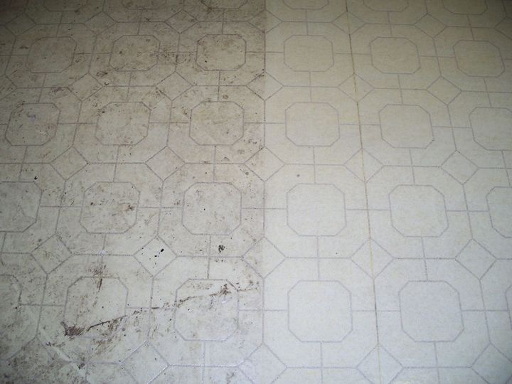 Close-up of a dirty, light-colored patterned floor with scuffs and stains