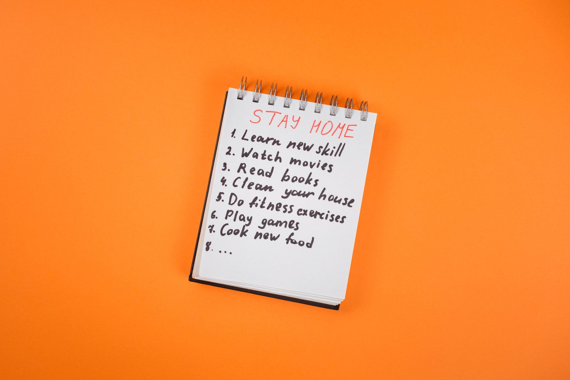 A note pad with a to do list written on it, the title of the list says Stay Home