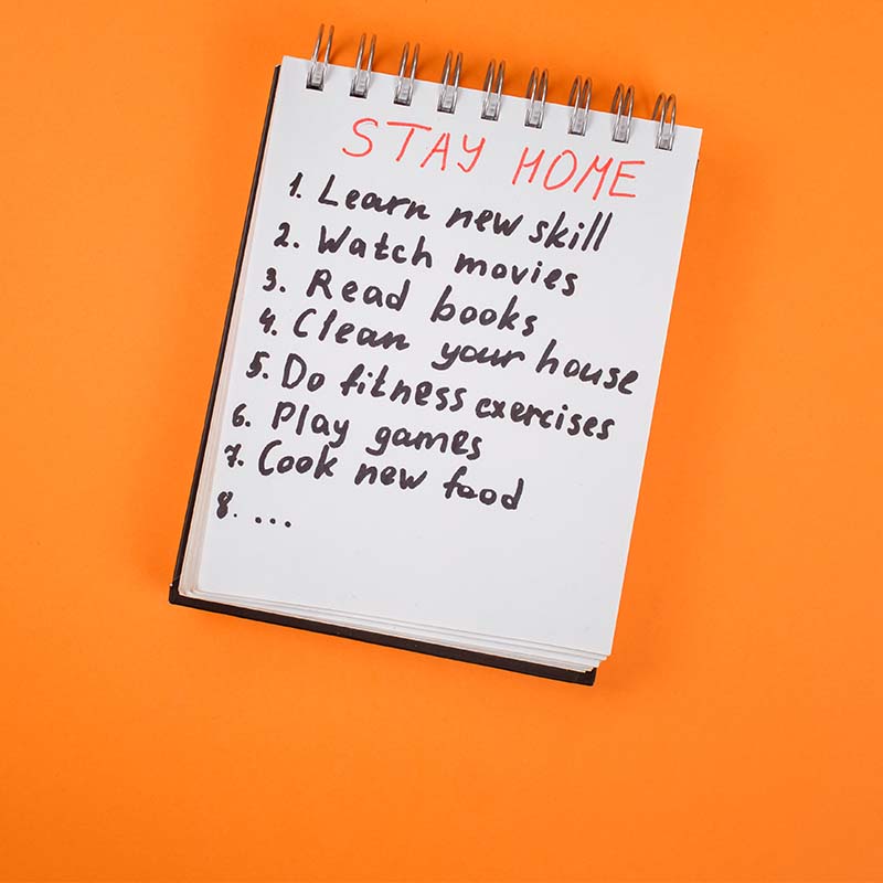 A note pad with a to do list written on it, the title of the list says Stay Home