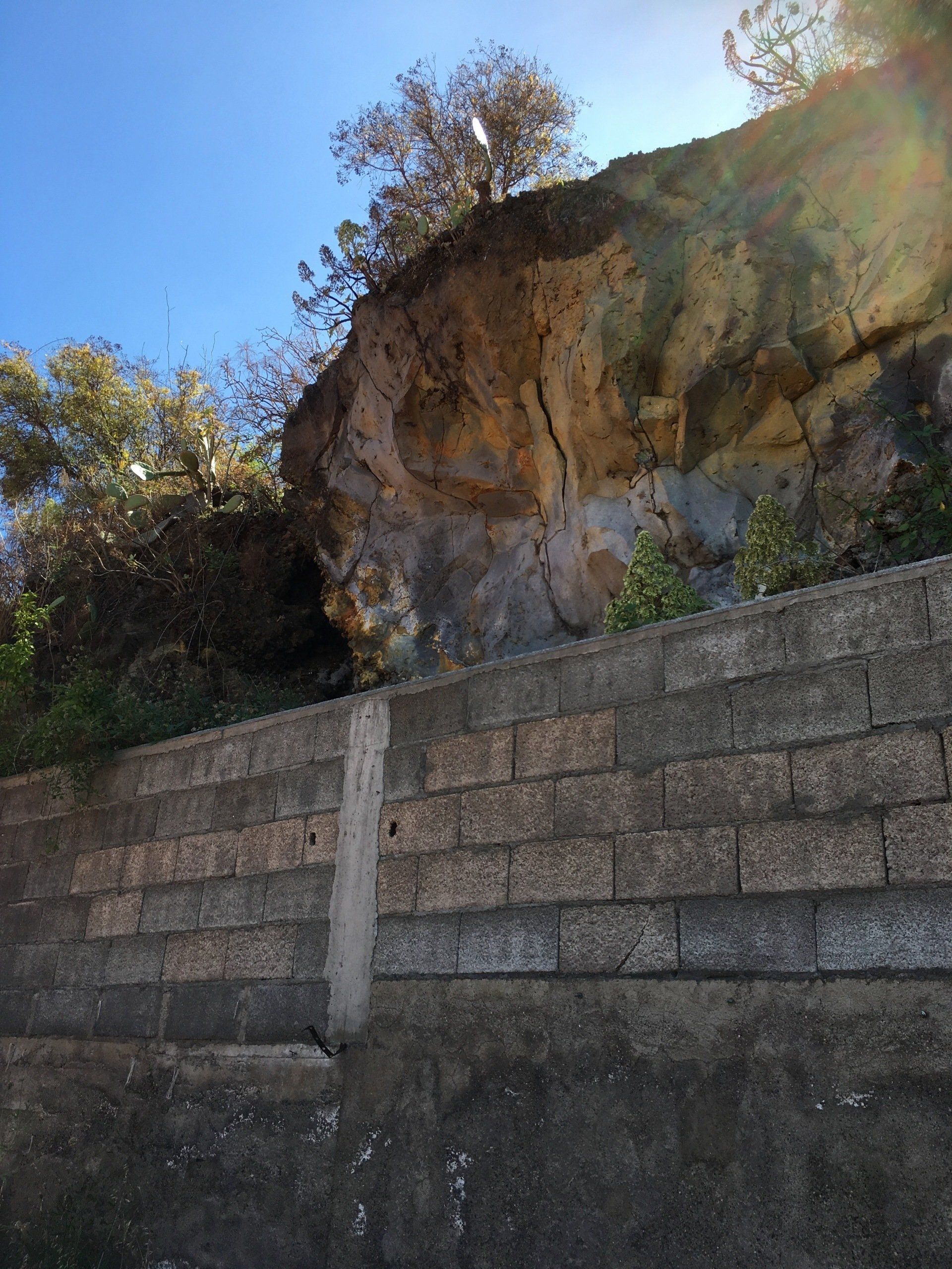 Side of cliff face showing that property is built into side of cliff