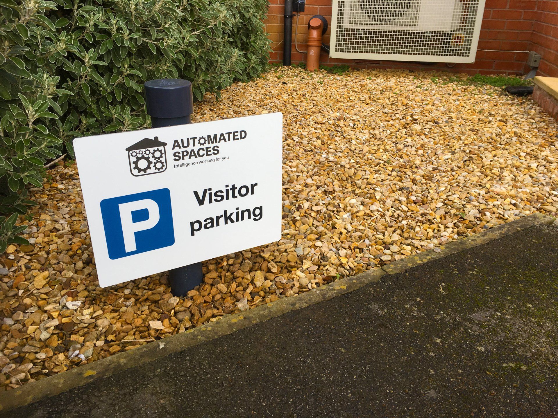 Visitor parking sign outside the Automated Spaces Smart Home Show House
