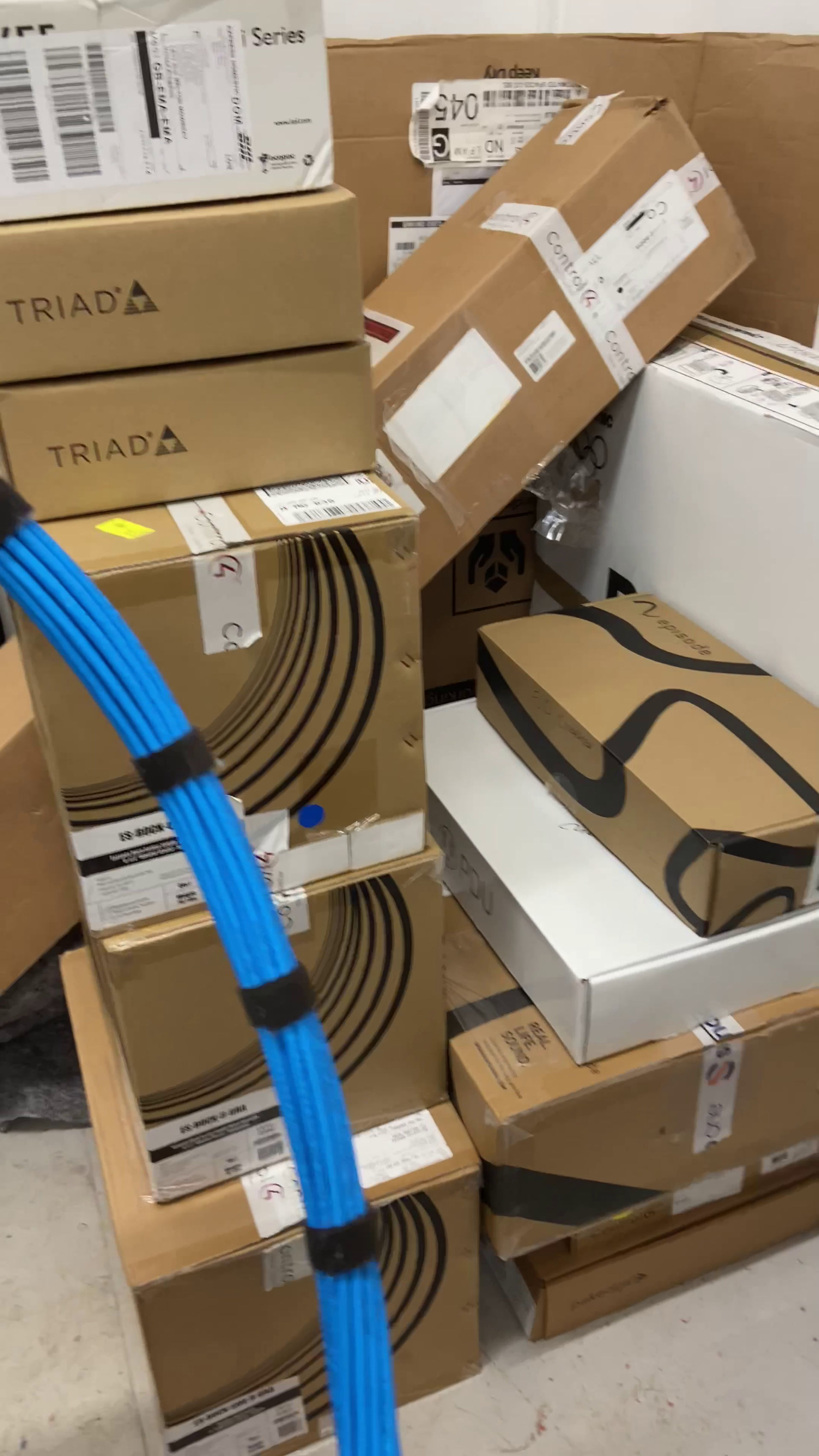Boxes stacked in a room, some with 
