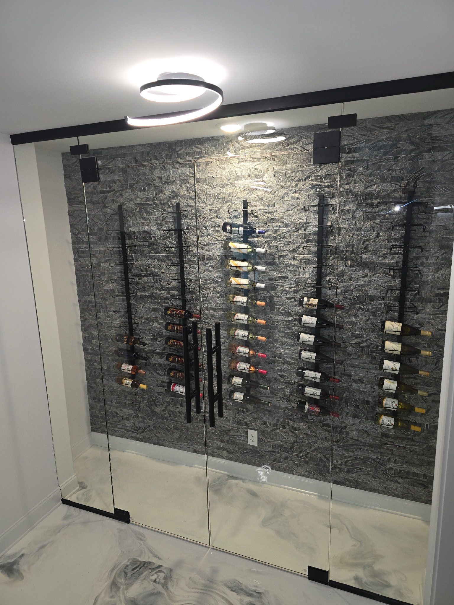 Modern interior wall display with rows of hanging items and shelves under a circular ceiling light