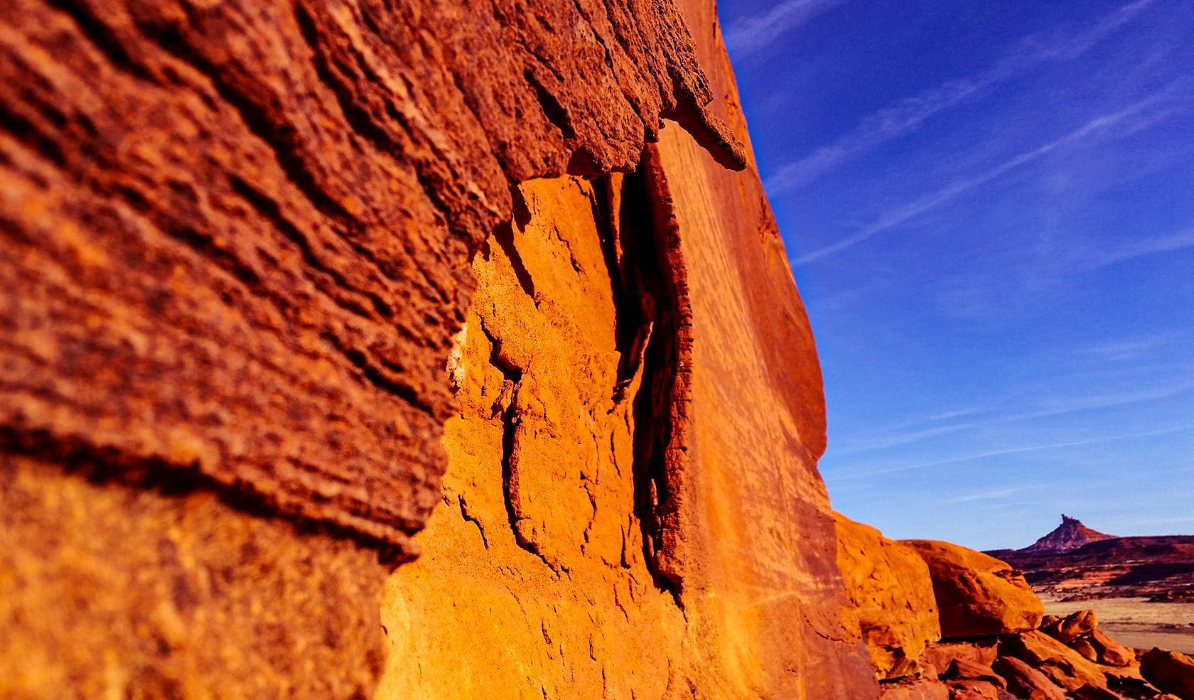 A person is standing on a rock in the middle of a canyon.