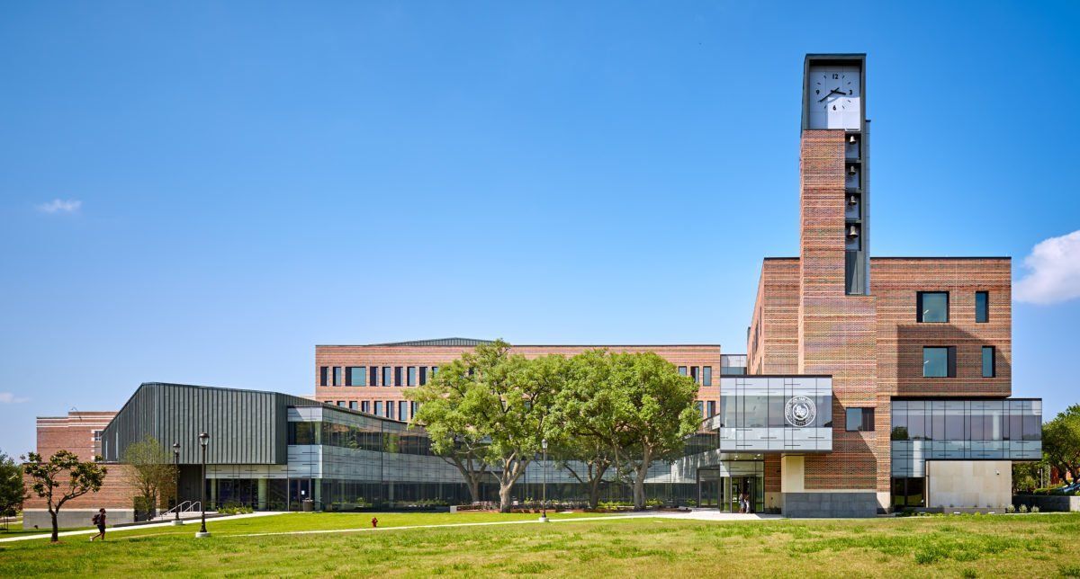 A large brick building with a clock tower on top of it.