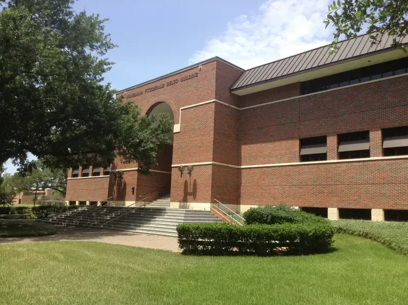 A large brick building with stairs leading up to it
