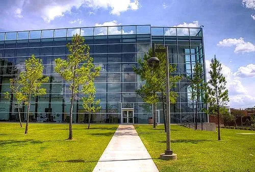 A large glass building with trees in front of it