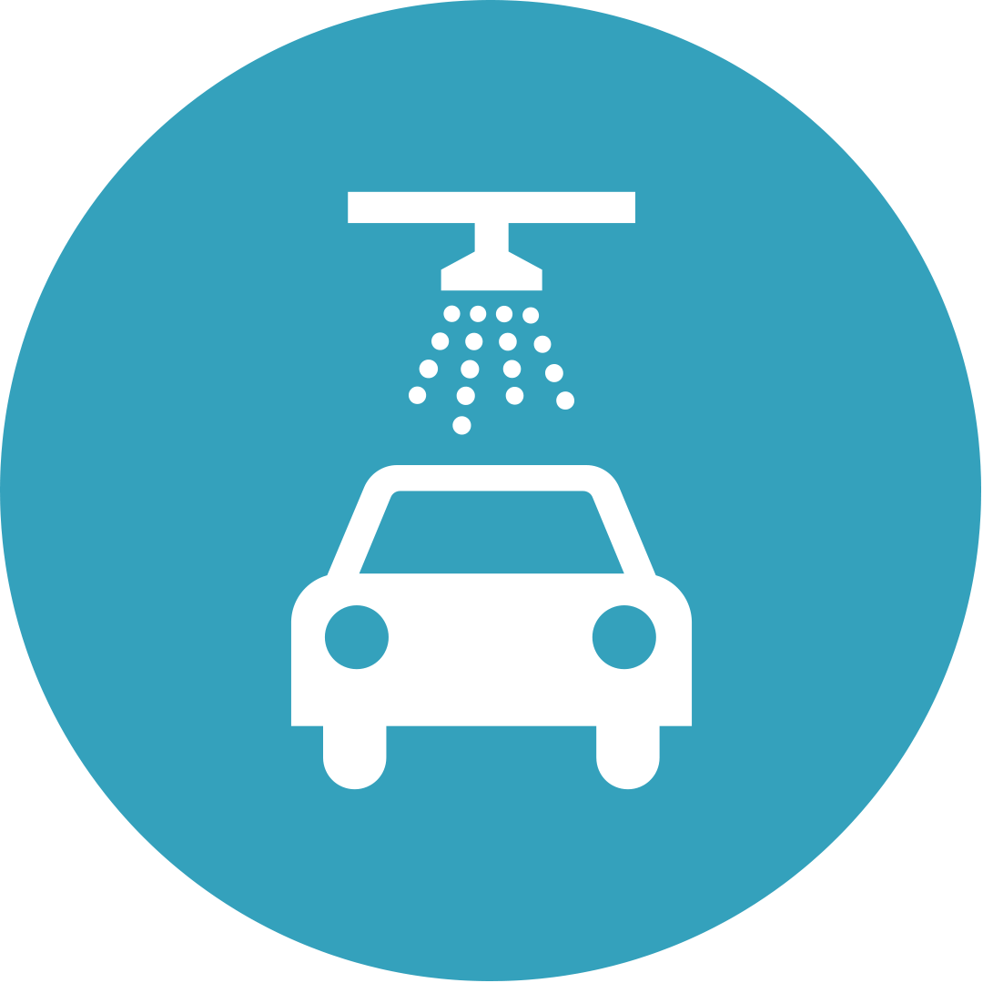 Car being washed at a car wash, white car and water droplets against a blue background.