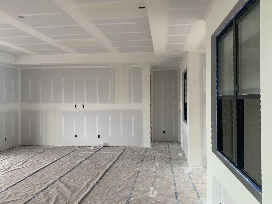 A room with a lot of white walls and a window.