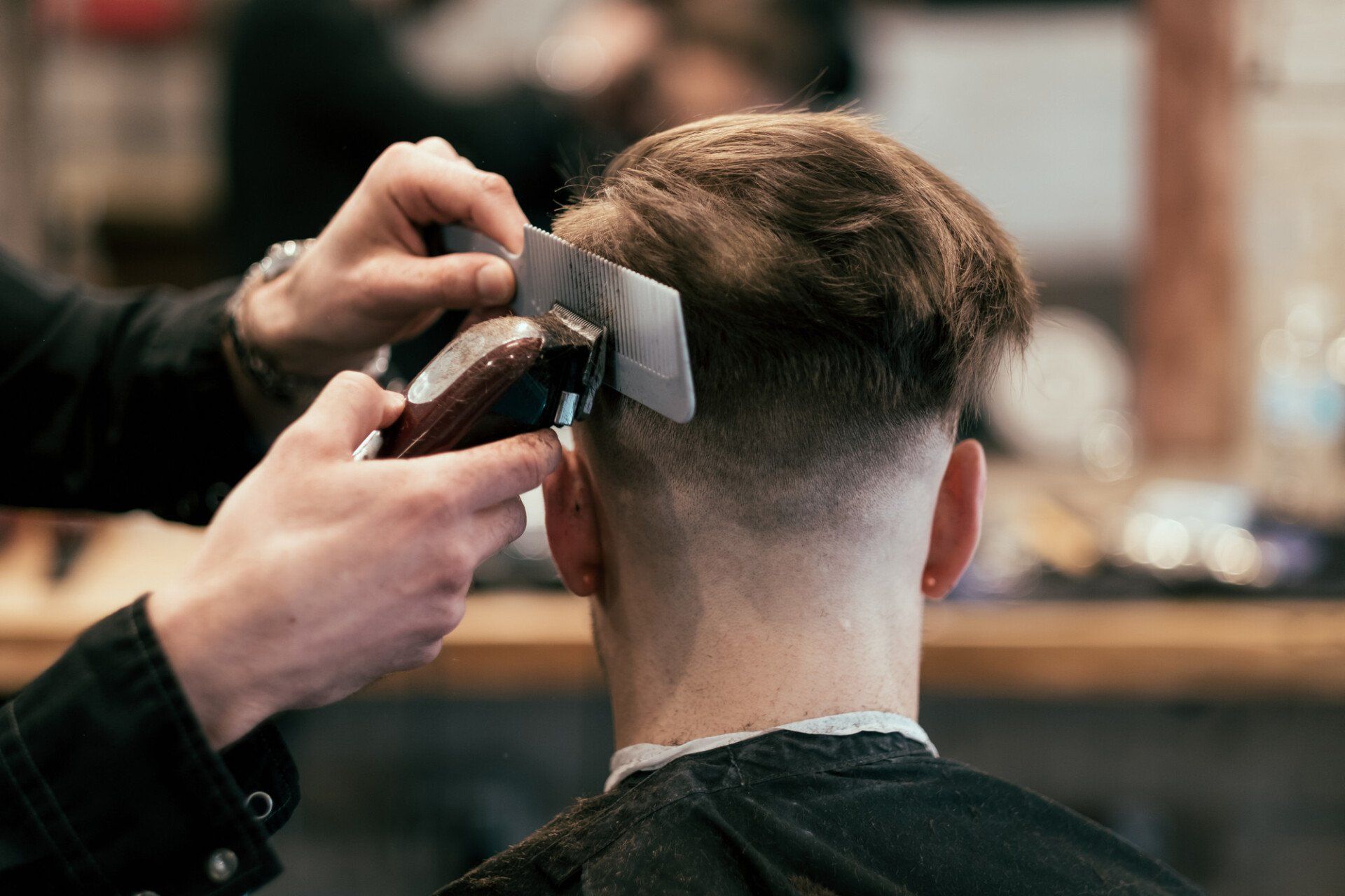 rear view of man having his hair shaved