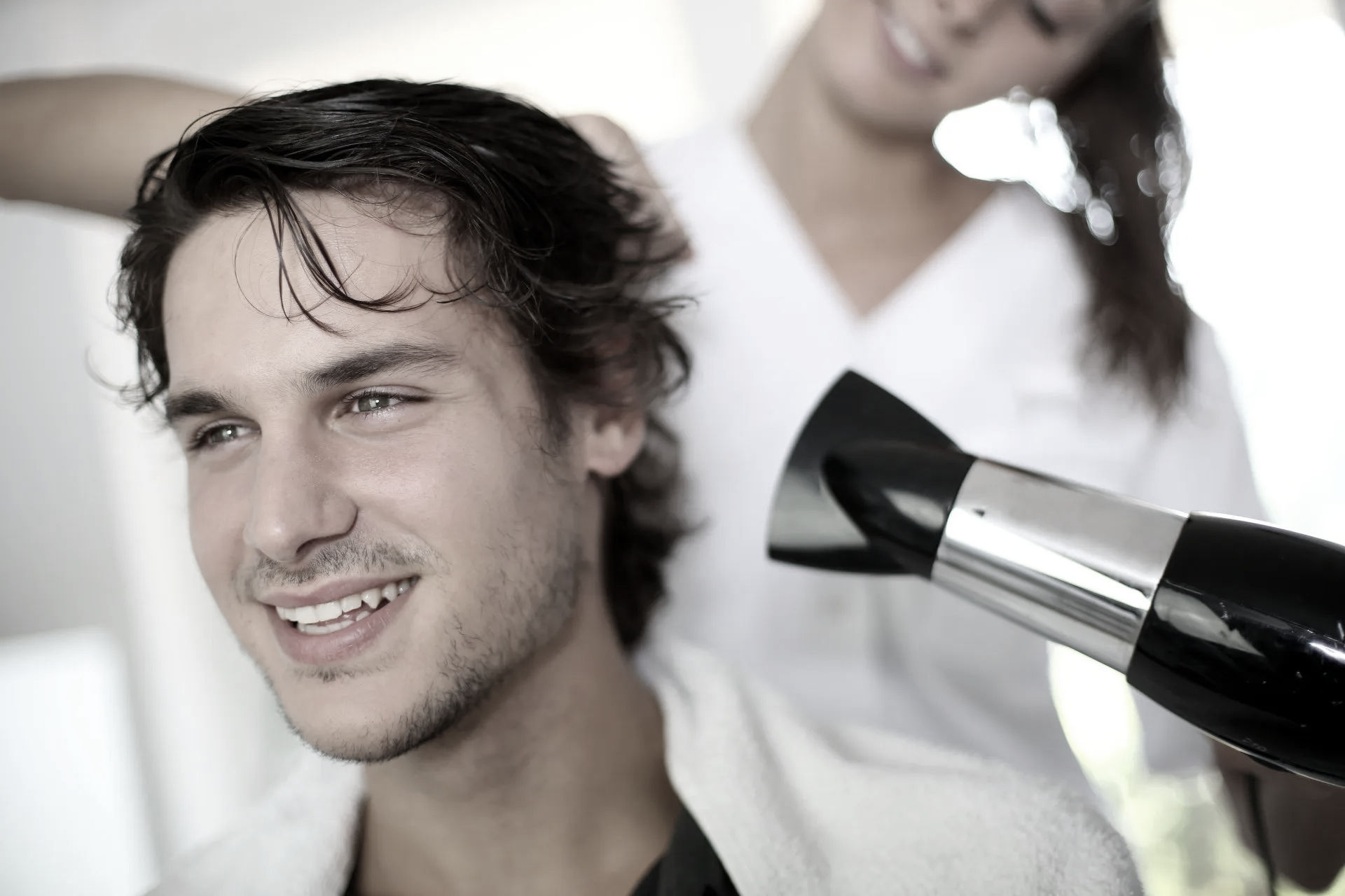man having his wet hair blow dried