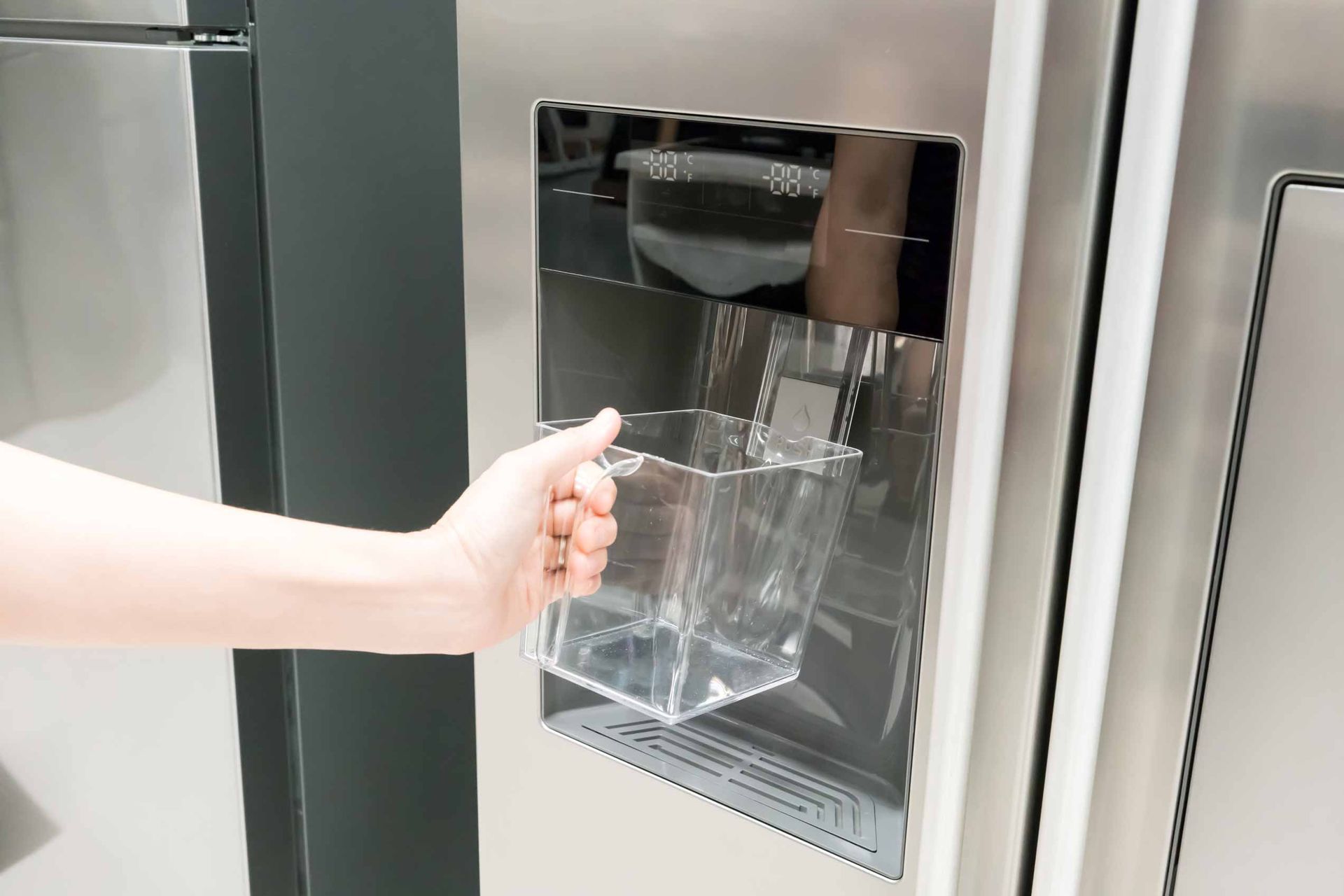 Hand placing a glass bowl into a microwave oven