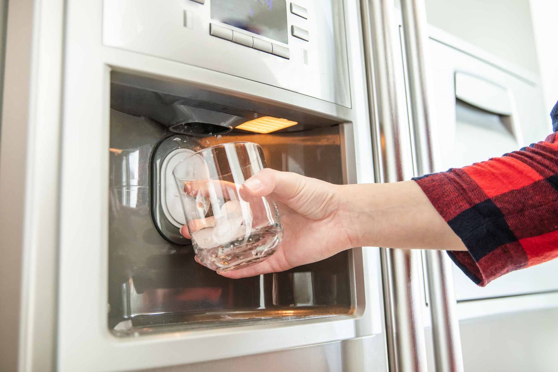 Hand placing a glass bowl into a microwave oven