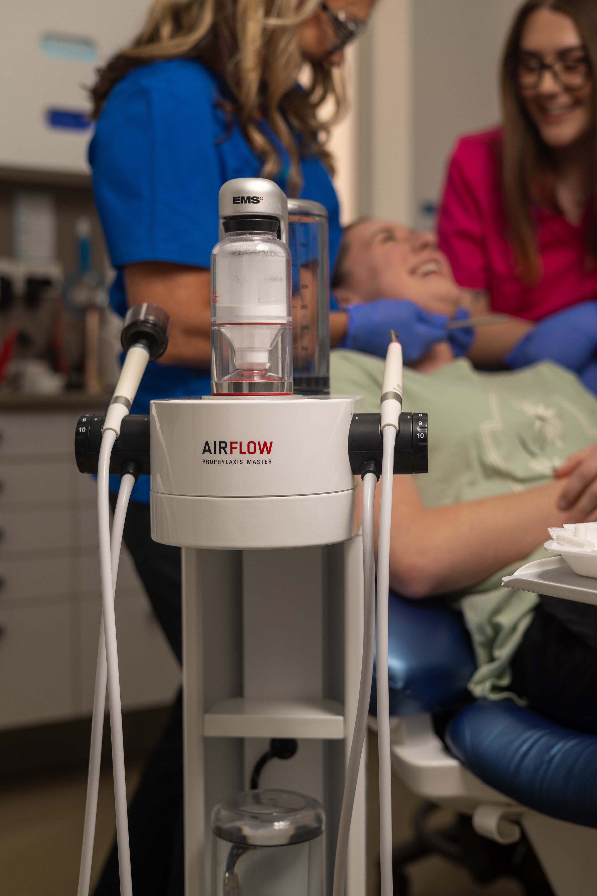 A woman is standing next to a machine that says Airflow on it.