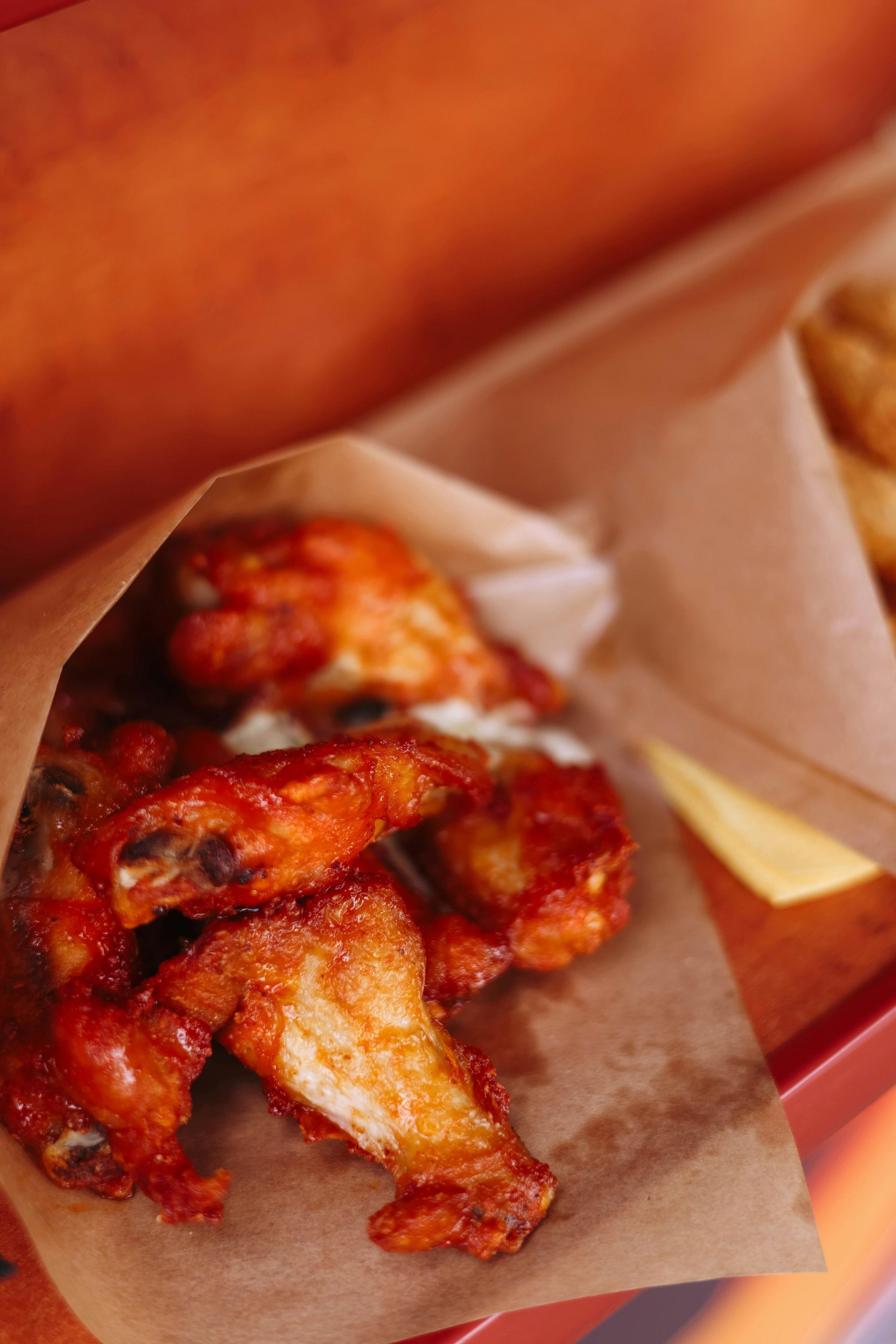 Juicy hot wings on plate.