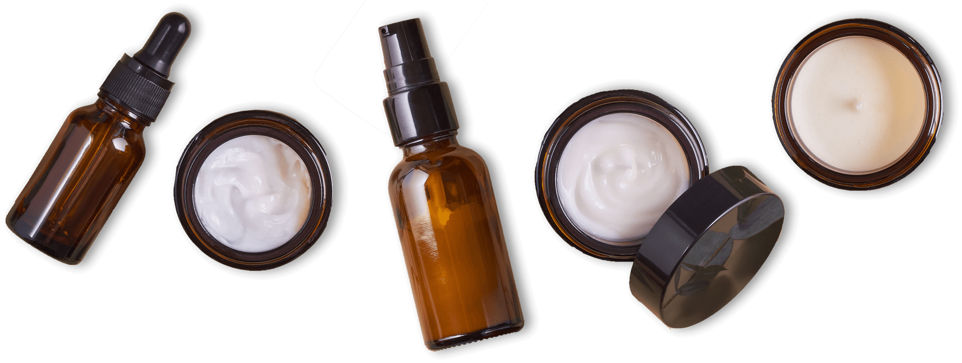 Two amber dropper bottles with black caps, plus open cream-colored jar lids on a white background