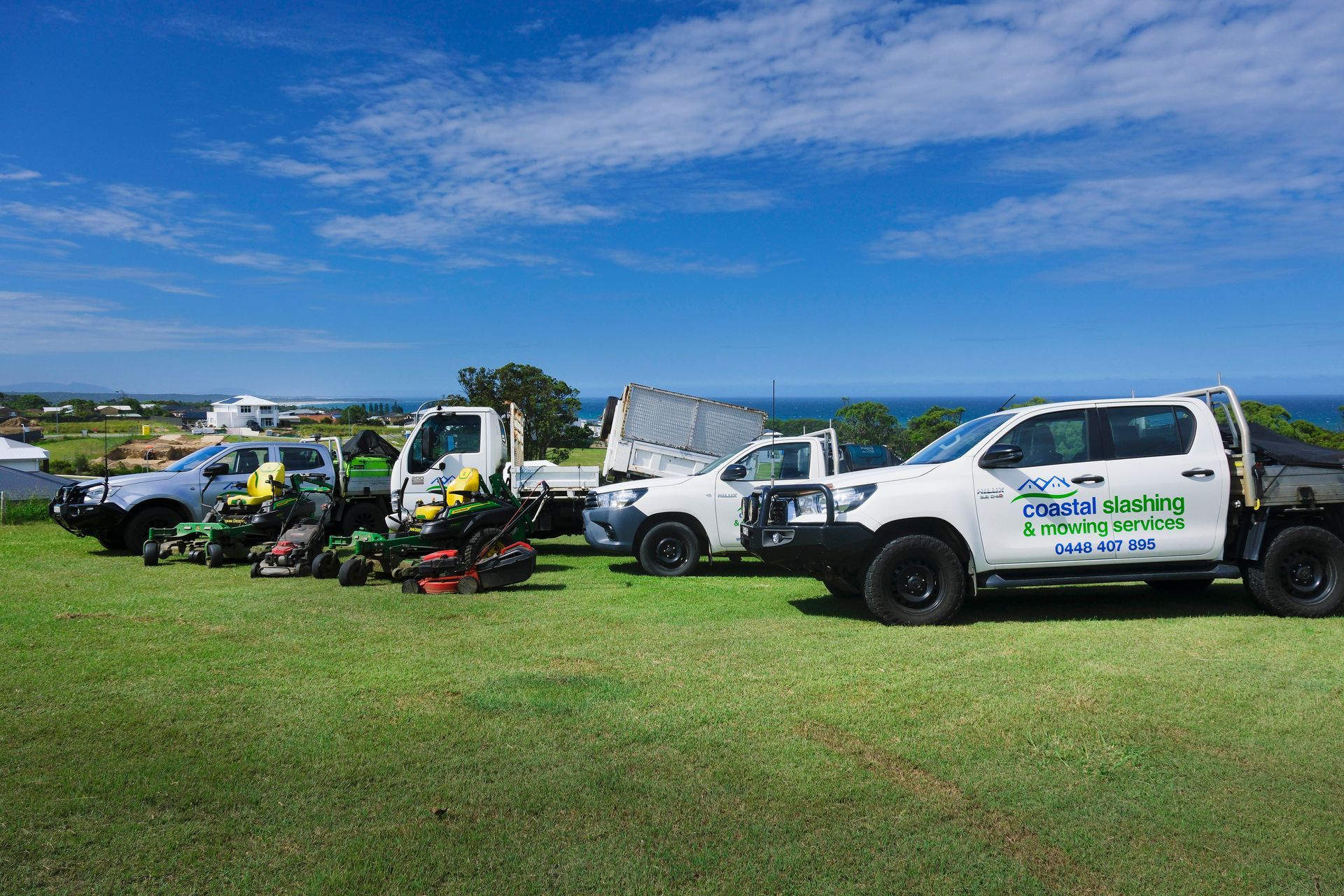 A Fleet of Work Trucks and Commercial Mowers Parked — Coastal Slashing & Mowing Services In Old Bar, NSW