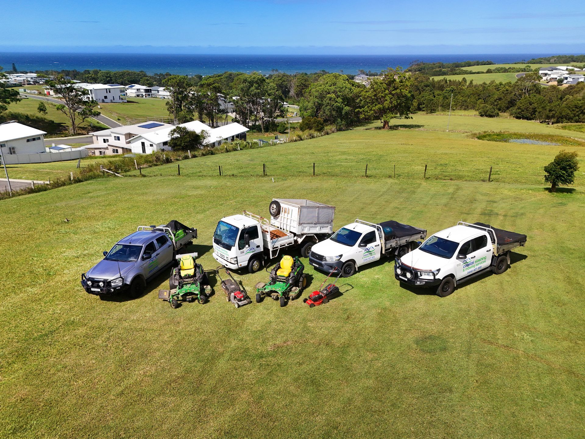 A Fleet of Three Work Trucks and Various Landscaping Mowers — Coastal Slashing & Mowing Services In Hallidays Point, NSW