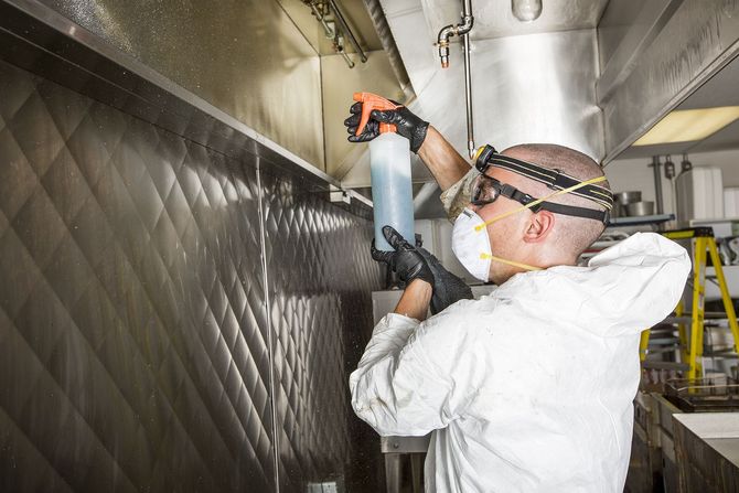 Specialist in hazmat suit sealing air ducts for mold safety.