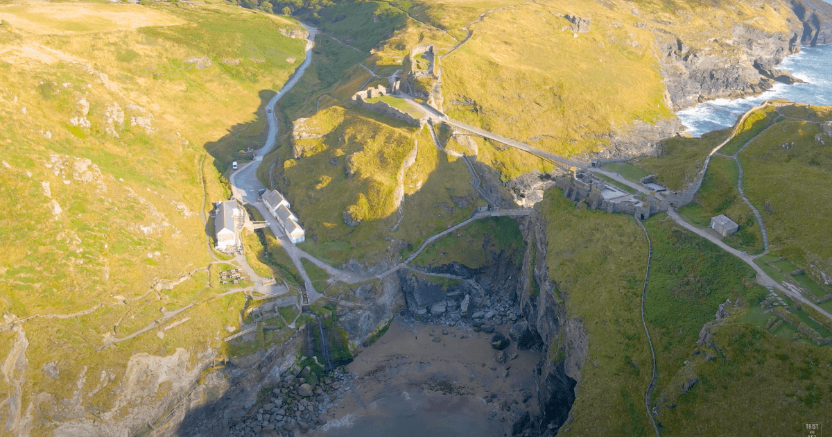 an aerial view of a Tintagel Castle and bridge
