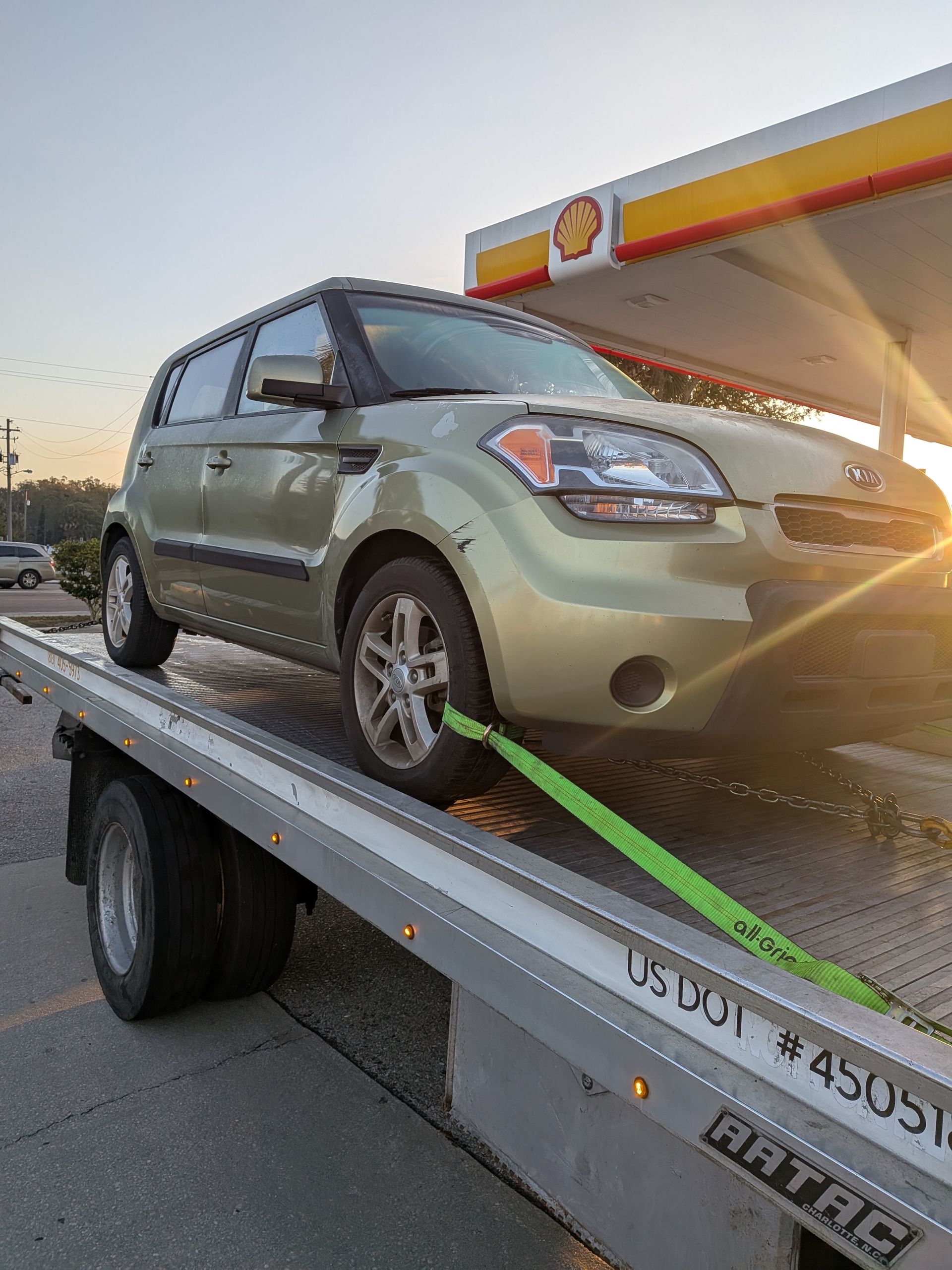 Compact vehicle safely secured on a Riverview Towing flatbed during roadside recovery in Riverview, Florida.