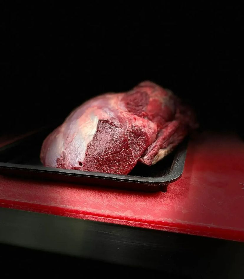 A Piece Of Raw Meat Is Sitting On Top Of A Plastic Tray — Lakim Butcher In Parap, NT 