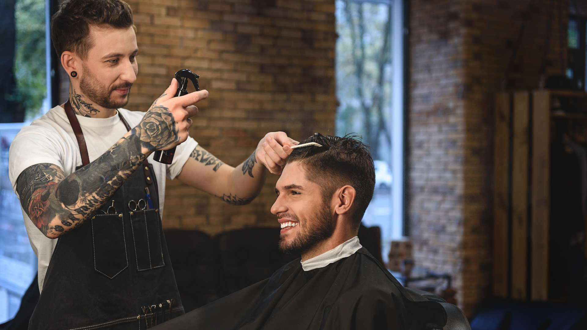 Barber giving a haircut to his client