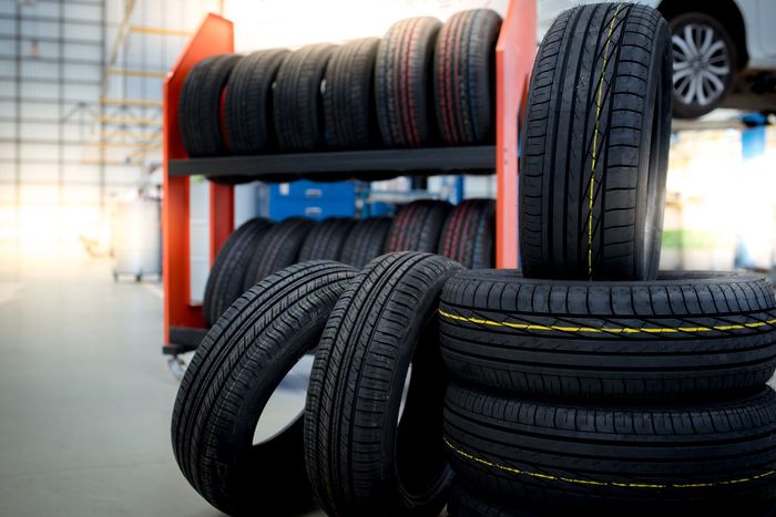 A bunch of tires are stacked on top of each other in a store.
