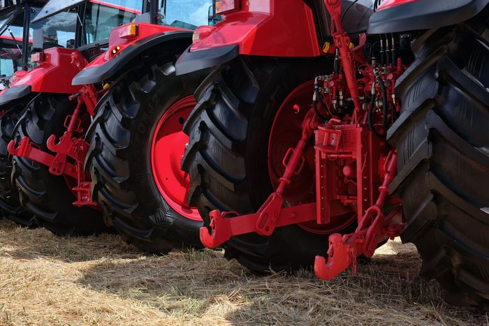 A pair of tractor tires are laying on the ground