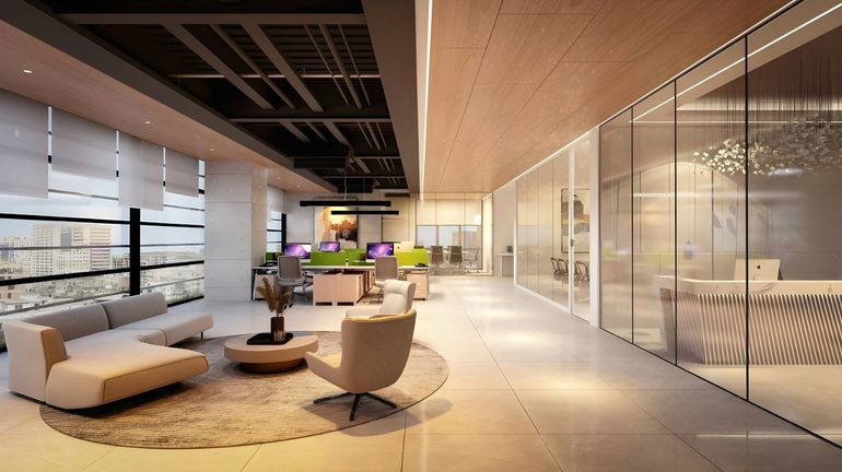 Modern office lounge with white sofas, round table, and glass-walled meeting rooms under warm lighting