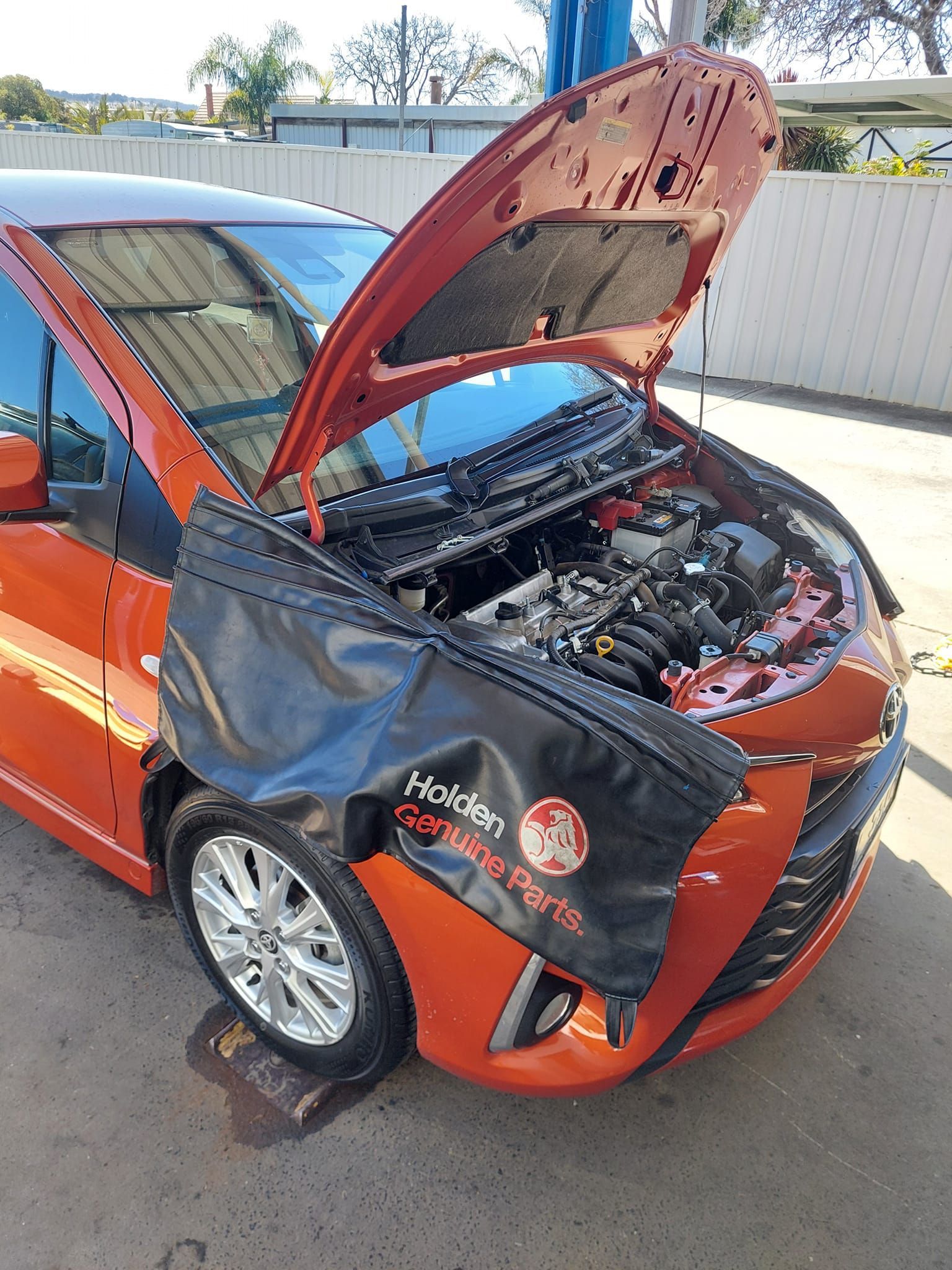 An Orange Car With Its Hood Open in a Repair Shop — TasMech Auto Services In Mornington, TAS