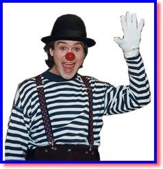 Clown wearing a black hat, red nose, striped shirt, suspenders, and white gloves, waving with a smile.