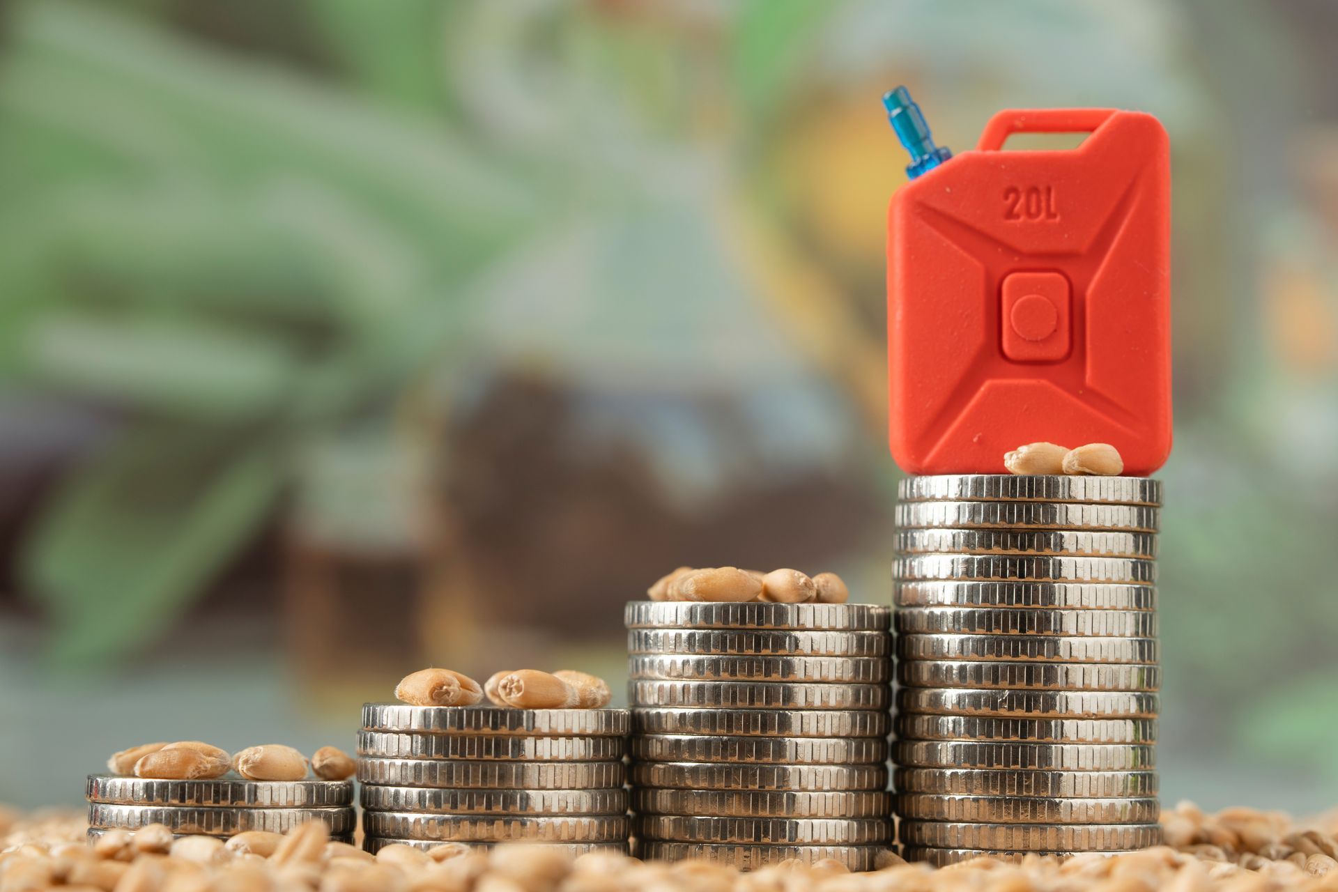 Stacks of coins with a red fuel can on top, symbolizing rising fuel costs