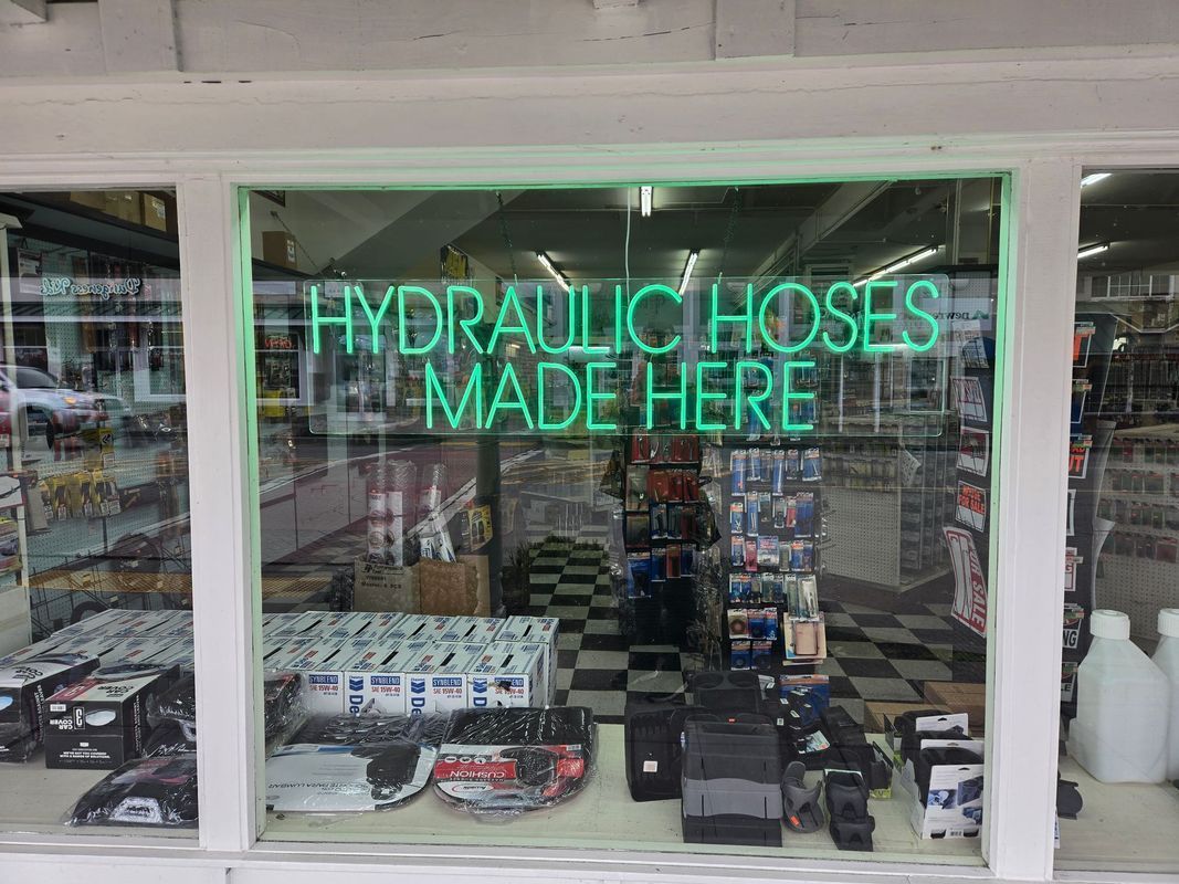 Storefront with green neon sign: 