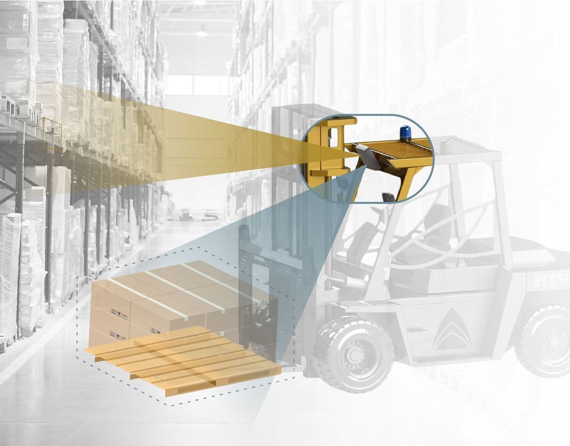 Forklift with a digital camera overlay showing the view of the forks aligning with a pallet in a warehouse.