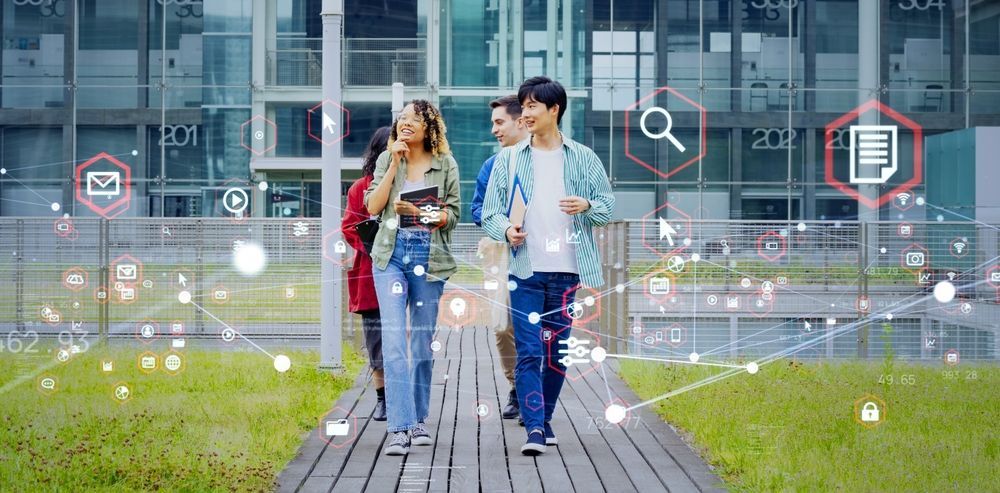 Three people walking on a wooden path in front of a glass building, with digital icons overlaid.
