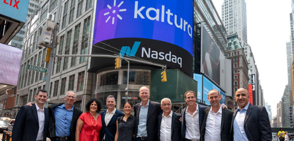 Group posing in Times Square with Nasdaq and Kaltura billboards overhead