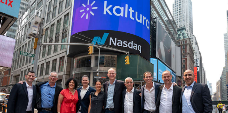 Group of people posing in front of Nasdaq and Kaltura billboards in Times Square