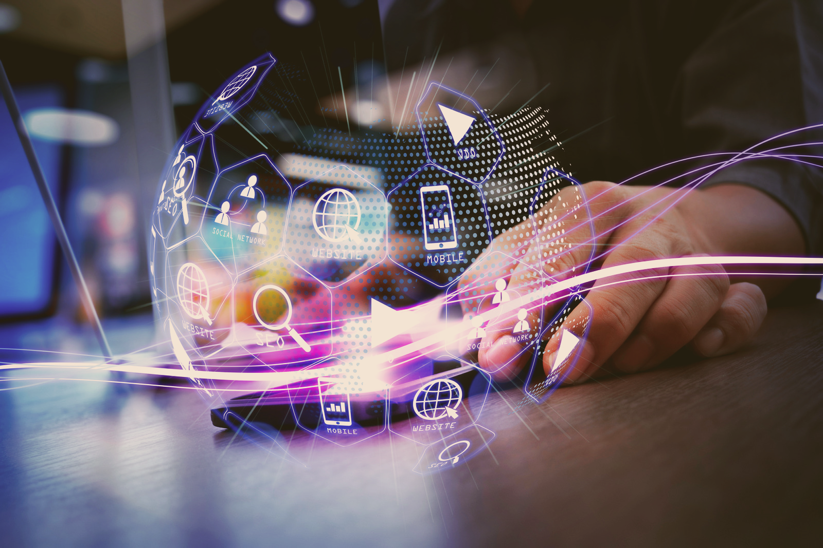 Hands using a tablet with glowing digital interface icons and purple light trails on a desk